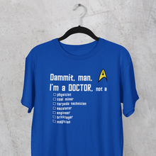 Load image into Gallery viewer, Star Trek's Blue Shirt - Dammit, man, I'm a DOCTOR, not a...