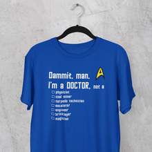 Load image into Gallery viewer, Star Trek&#39;s Blue Shirt - Dammit, man, I&#39;m a DOCTOR, not a...
